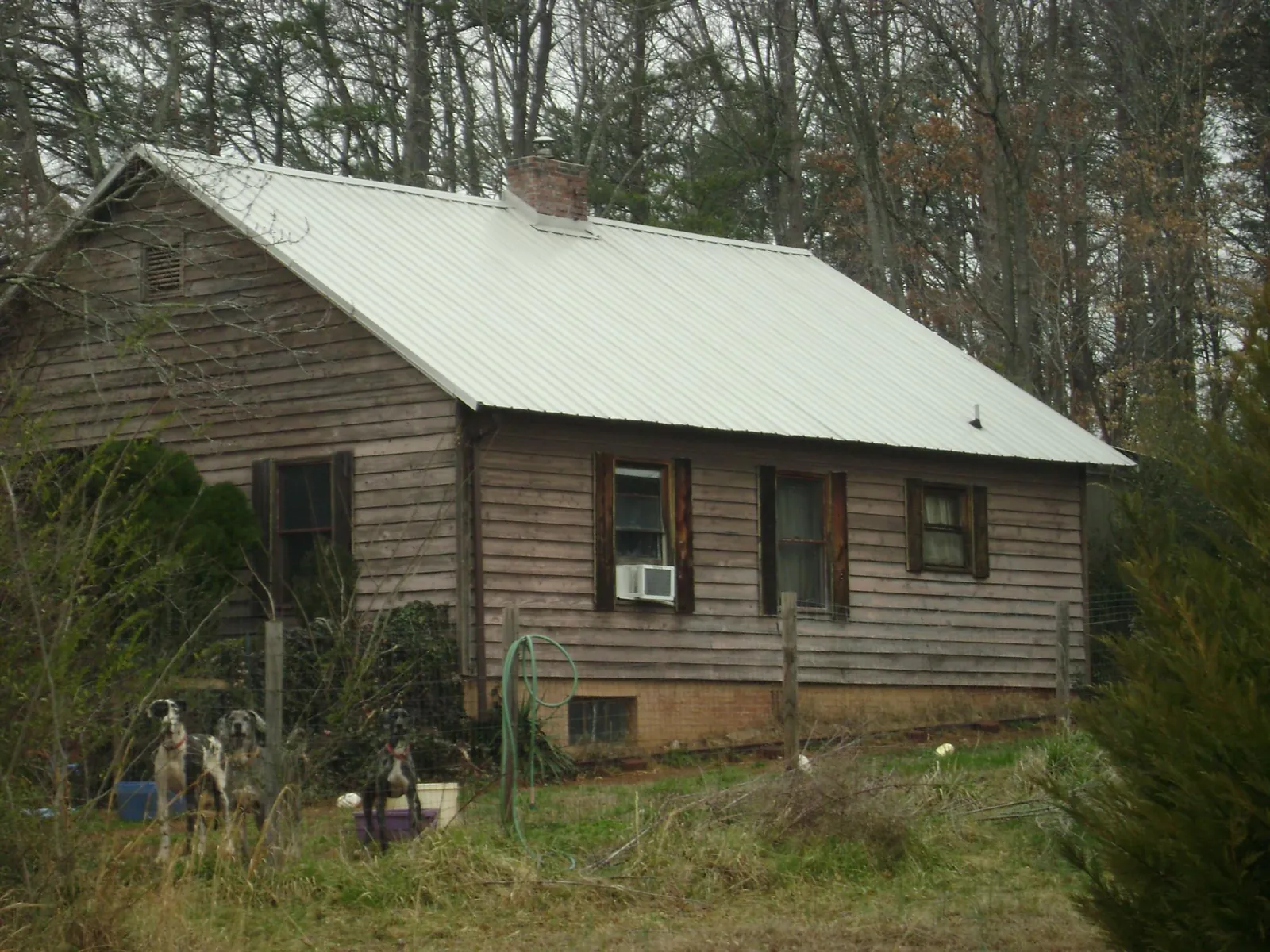 White metal roof on an old wood sided farmhouse, from a Metal Roof Installation job in Albin
